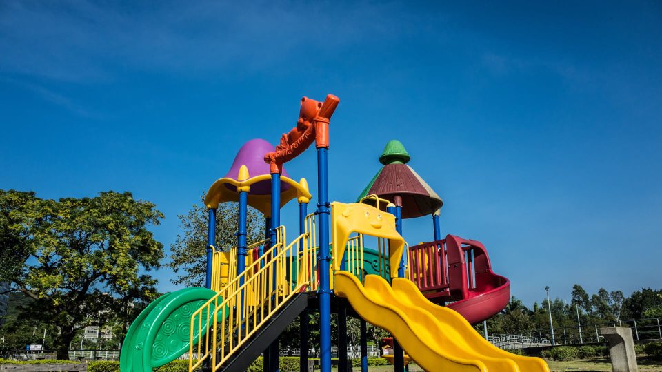 a colorful playground with slides and swings at The GreenLeaf