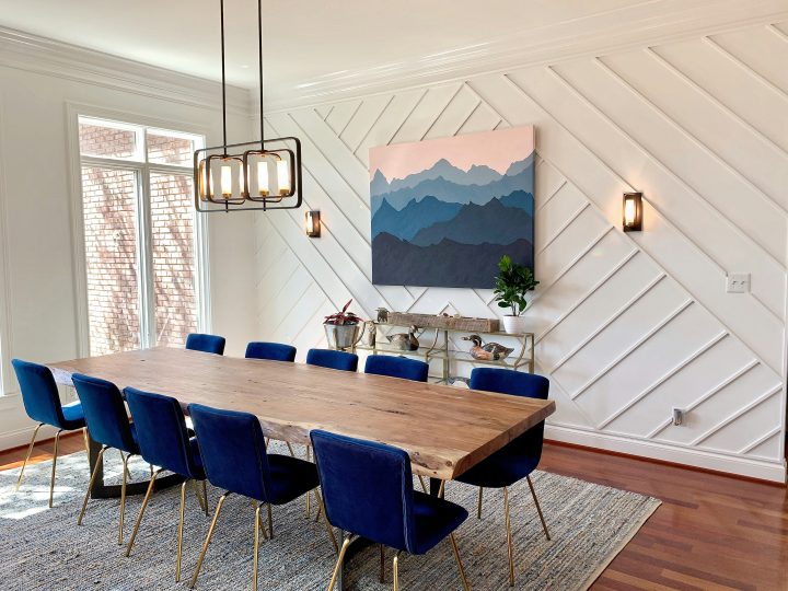 a dining room with blue chairs and a wooden table at The GreenLeaf